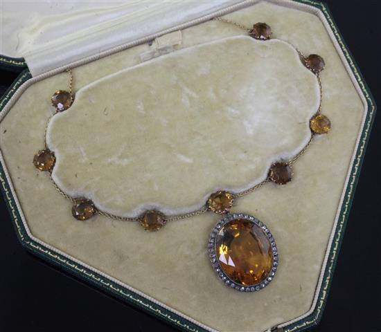 An Edwardian gold, diamond and oval cut citrine drop pendant on fine chain with tourmaline spacers, in S. J. Phillips fitted case,